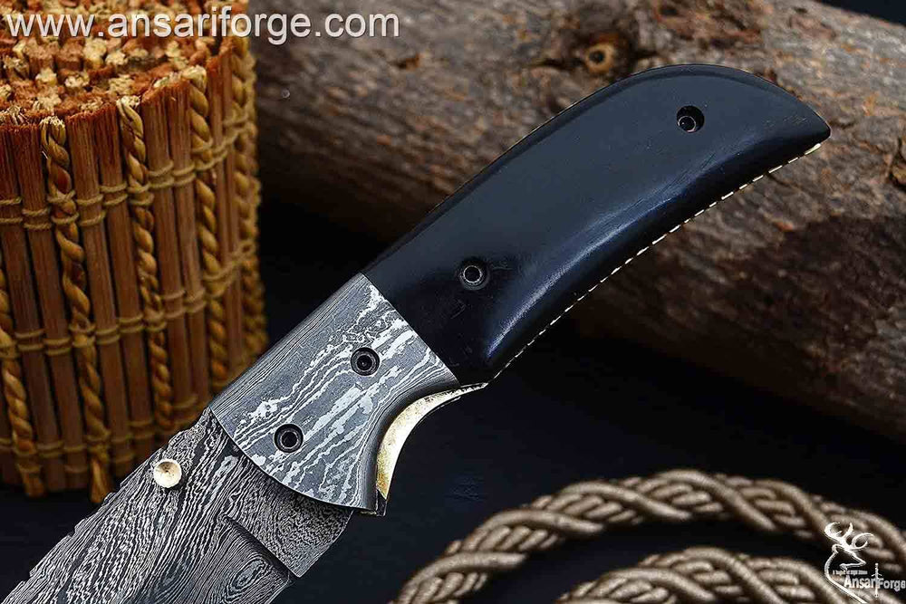Compact handmade Damascus folding knife for everyday carry.