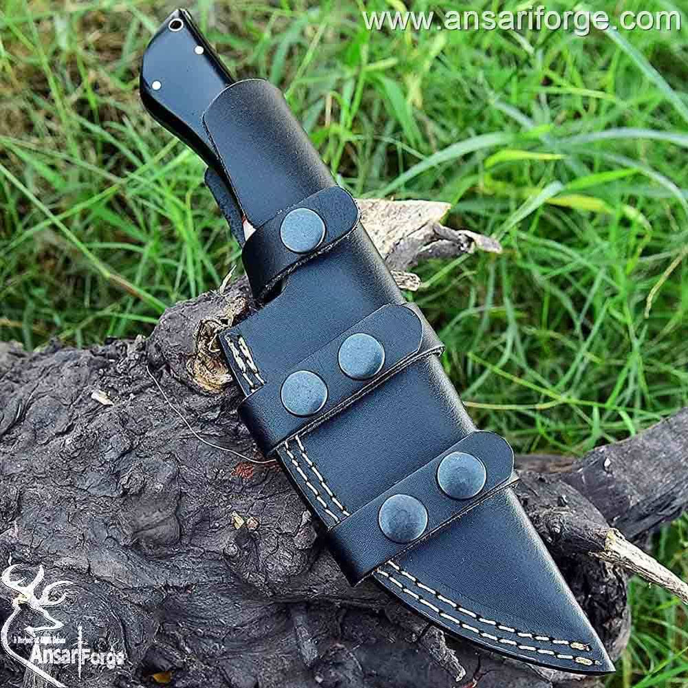 Full tang handmade Damascus hunting knife in a leather sheath.