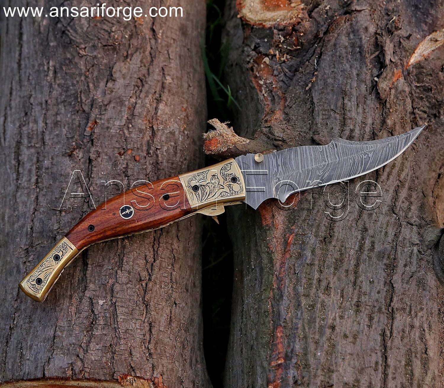 Damascus Folding Knife with a twist pattern blade, walnut wood handle, and engraved brass bolsters, displayed open.