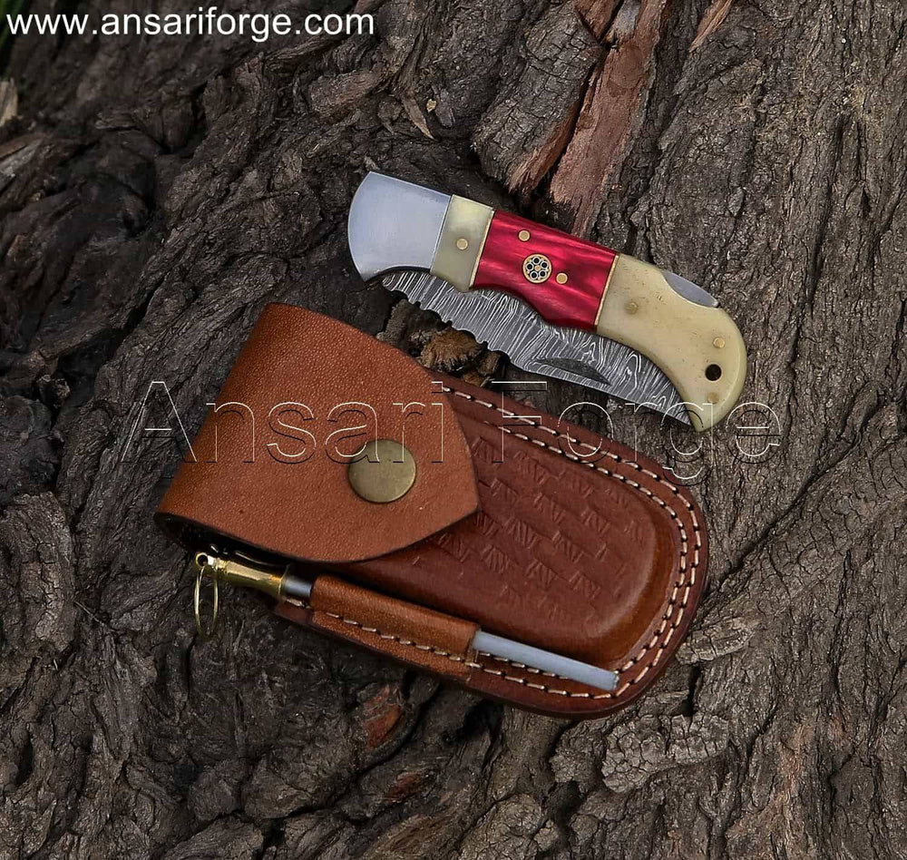 Damascus folding pocket knife with a twist pattern blade, camel bone handle, and cowhide leather sheath.