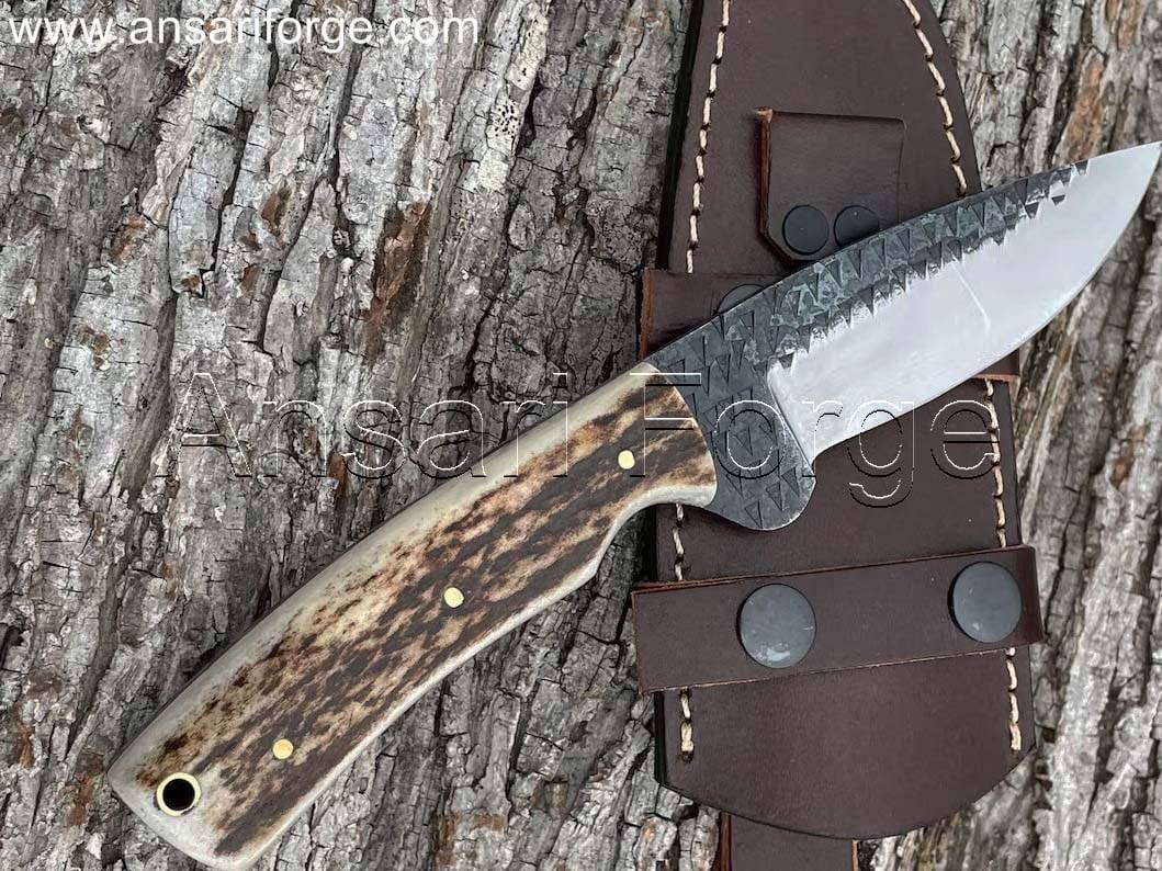 Hand-forged knife with stag antler handle and leather sheath.