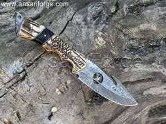 Best Handmade D-Skinner Damascus hunting knife with stag antler handle and leather sheath.