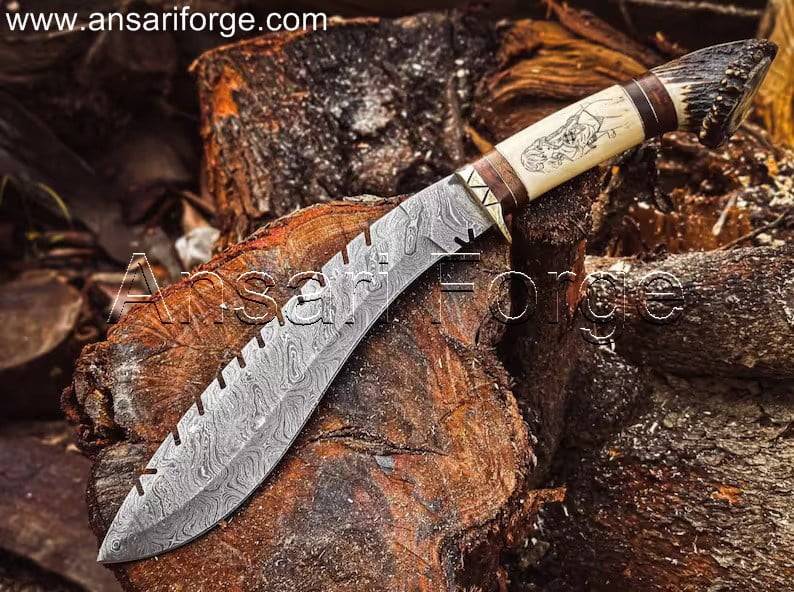 Beautiful Damascus Best kukri knife with a twist pattern blade, brass guard, camel bone and stag antler handle, and leather sheath. Overall length 16 inches.