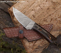 Hand-forged Damascus hunting knife with twist pattern blade, Wenge wood handle, and leather sheath. Overall length 8 inches.