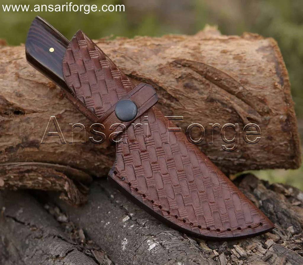 Hand-forged Damascus skinning knife (1095 & 15n20 steel, 59 HRC) with 4" blade, Wenge wood handle, and genuine cowhide leather sheath.