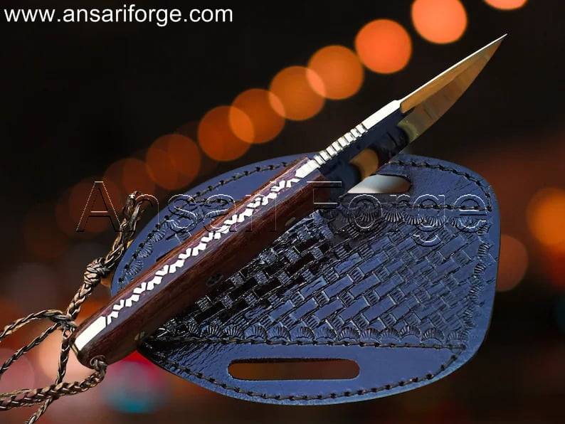 Close-up of the forged D2 steel blade with intricate file work on the spine.