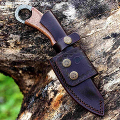 The Claw Damascus Backpacker Knife. Hand-forged Damascus steel blade with twist pattern, walnut wood handle, leather sheath. For hunting, camping, hiking.
