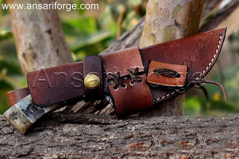 Beautiful Damascus Skinning Knife with Gut Hook, Ram Horn Handle, and Brown Leather Sheath