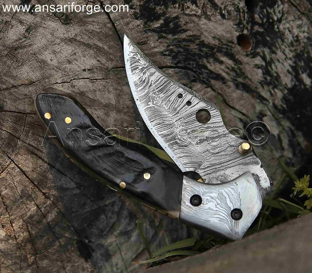 Damascus Pocket Knife by Ansari Forge with a 1095 & 15n20 Damascus steel blade, Himalayan sheep horn handle, and brass frame. Featuring a fire pattern, liner lock mechanism, and leather sheath.