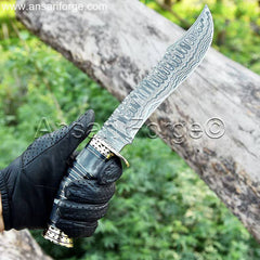 Person holding a Damascus Bowie Hunting Knife in the outdoors.