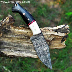 Damascus hunting knife with camel bone bolsters and buffalo horn handle.