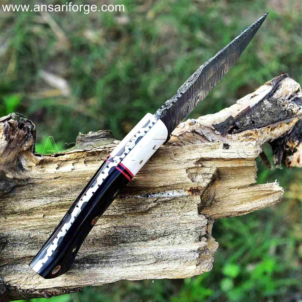 Damascus steel blade of hunting knife with twist pattern and file work.