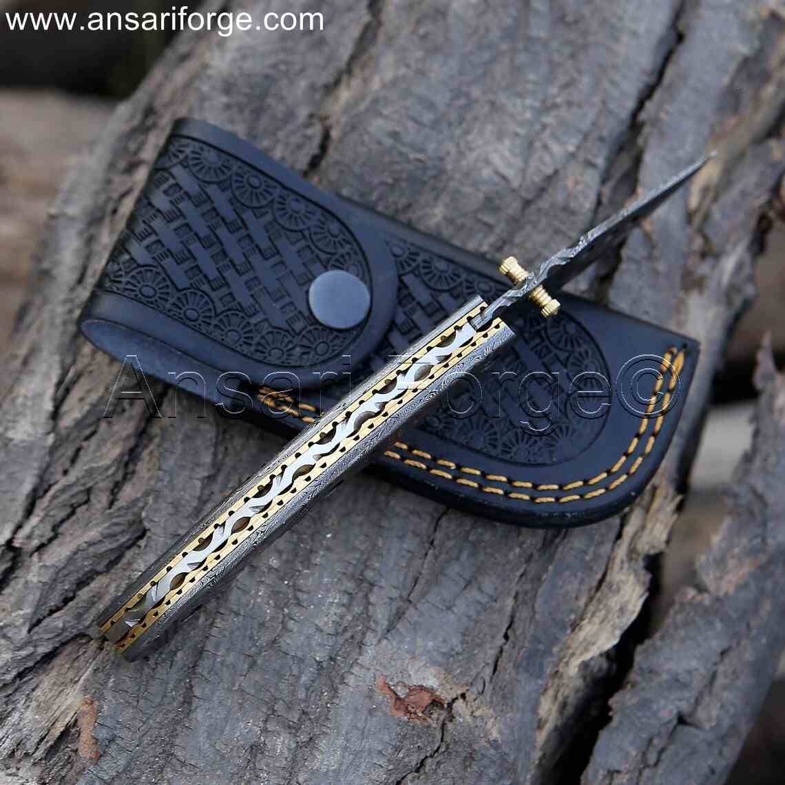 High-quality Damascus steel handle of pocket knife with detailed file work.