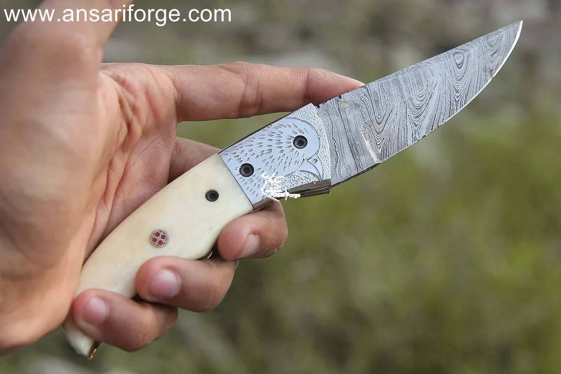 Sharp Eagle Damascus Pocket Knife: 1095 & 15N20 Damascus steel blade, camel bone handle, leather pouch.