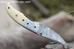Sharp Eagle Damascus Pocket Knife: 1095 & 15N20 Damascus steel blade, camel bone handle, leather pouch.
