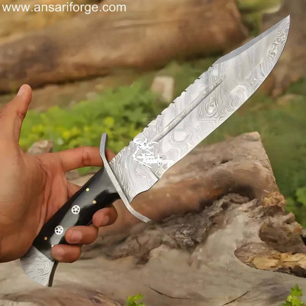 The Wanderer Damascus Bowie Knife held in hand: Showcasing the handle and overall design.