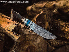 Rime Fixed Blade Antler Handle Damascus Knife Displayed on a Rustic Wooden