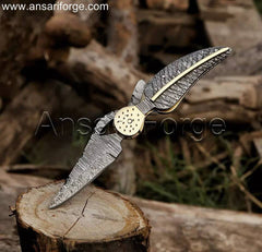 Custom Damascus pocket knife with hand-forged blade and handle.