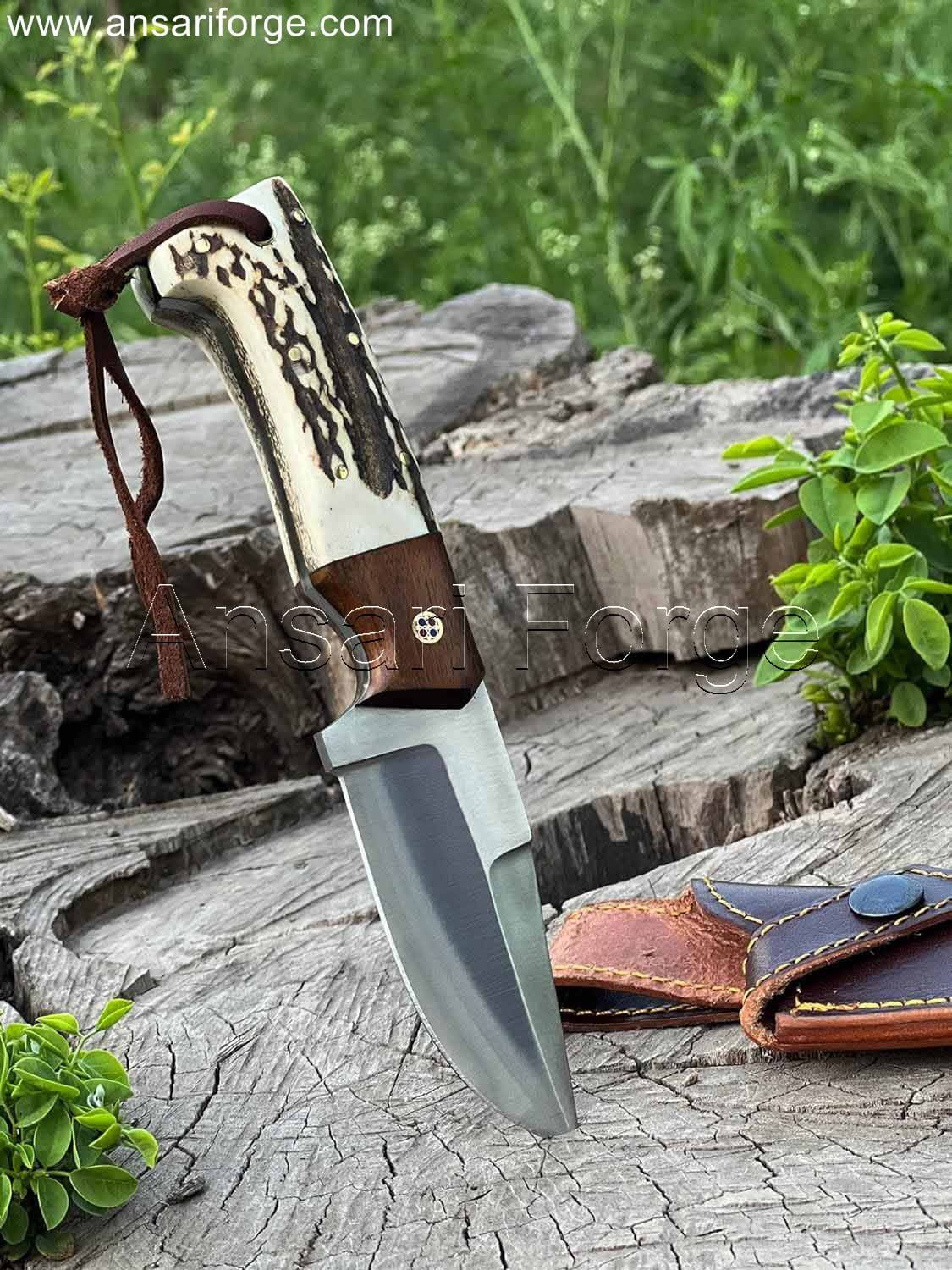 Handcrafted high carbon steel fixed blade hunting knife with stag/deer antler handle and rosewood bolsters, displayed in a cowhide leather sheath.