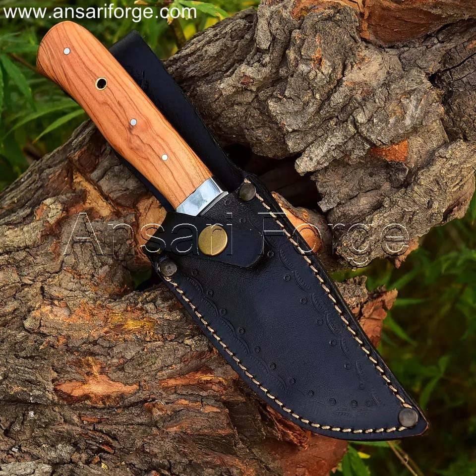 Handcrafted fixed blade hunting knife with drop point D2 steel blade, olive wood handle, and leather sheath. Perfect for camping, hiking, and wilderness adventures.