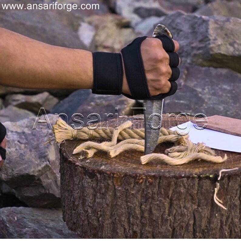 Markhor Hunter Damascus Steel Knife with camping gear, ideal for outdoor adventures.