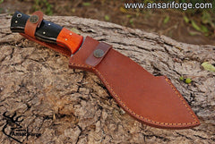Hand-forged Damascus steel hunting knife with a curved blade, buffalo horn handle, and Pakka wood bolsters.