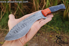 Hand-forged Damascus steel hunting knife with a curved blade, buffalo horn handle, and Pakka wood bolsters.