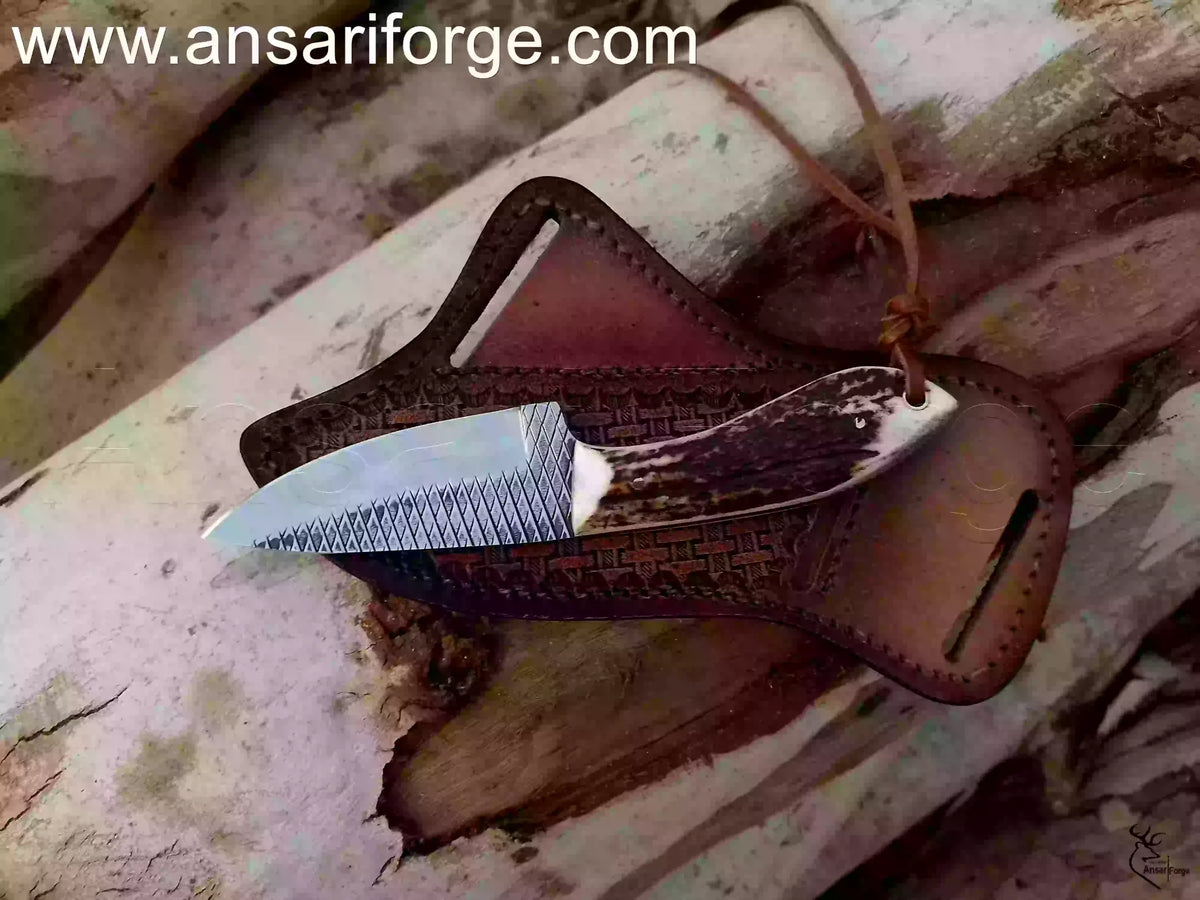 hand-forged Cowboy Knife with Sambar Stag handle and cowhide pancake sheath.