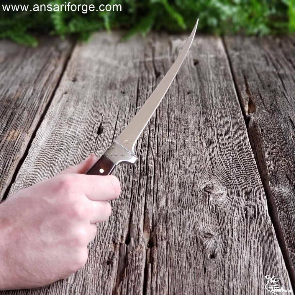 A fisherman showing size of salmon fillet in knife.