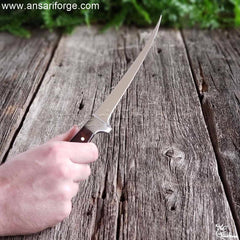 A fisherman showing size of salmon fillet in knife.