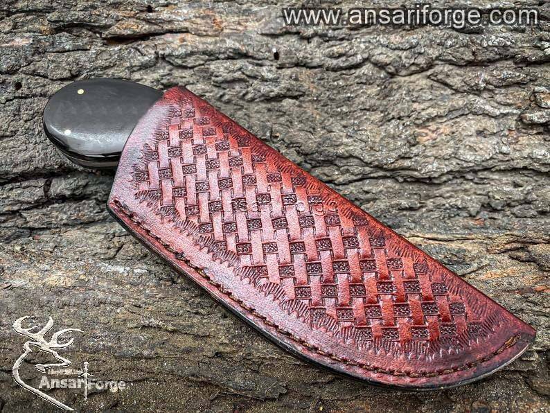 Genuine cowhide leather sheath for the Damascus skinning knife, highlighting craftsmanship and durability.