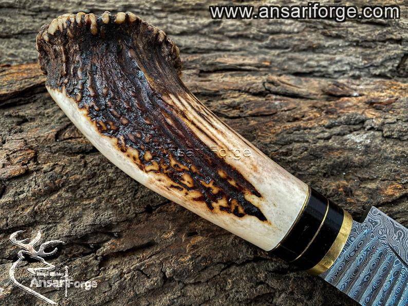 Deer antler handle of handmade Damascus hunting knife.
