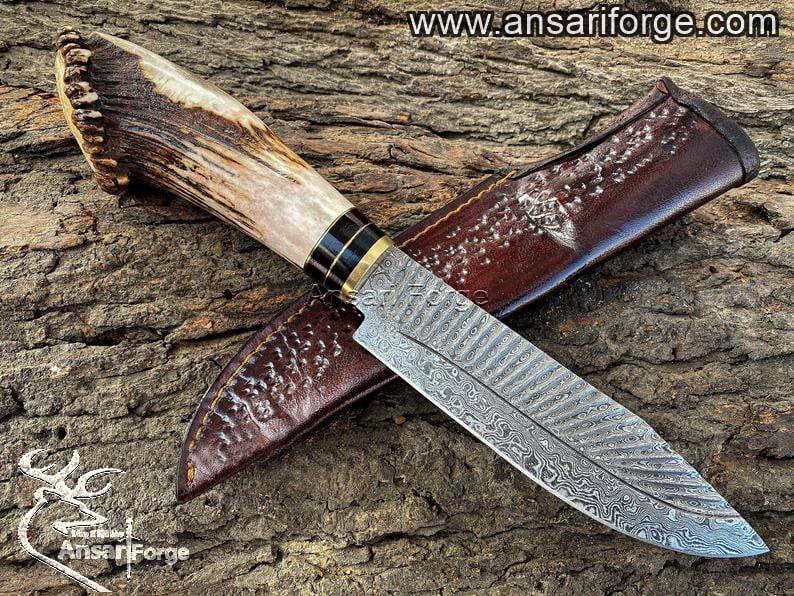 Custom made Forged Damascus steel Stag antler handle hunting knife with leather sheath.