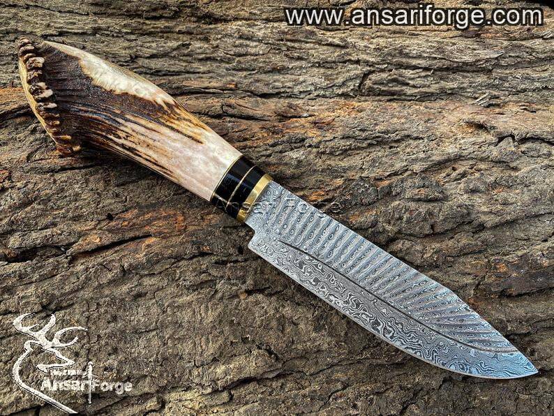 Damascus Hunting Knife with antler handle and brass bolsters.