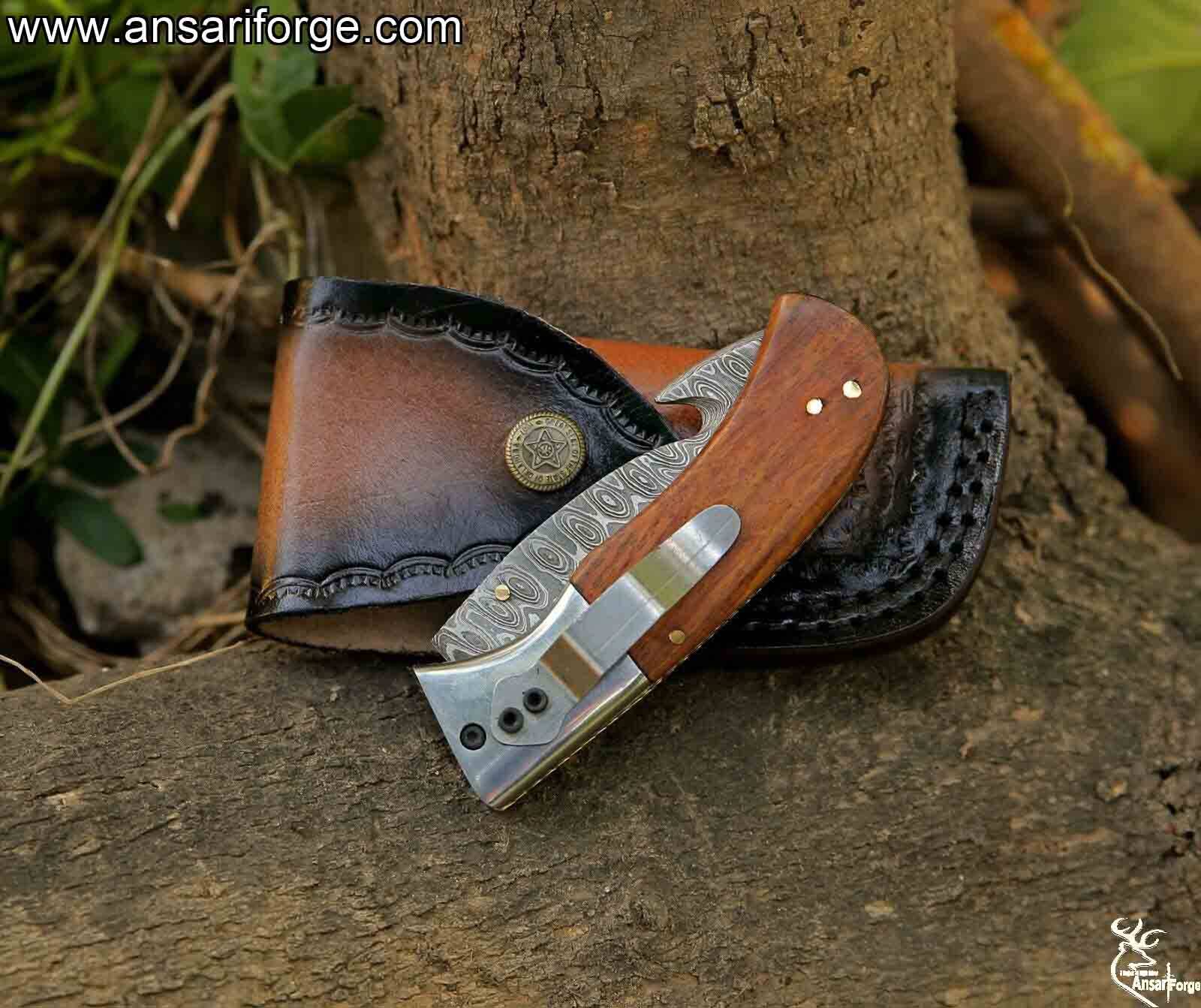 Closed Damascus pocket knife featuring a rosewood handle and brass accents, showcasing the intricate ladder pattern of the Damascus steel blade.