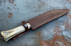 Viking seax knife in brown leather sheath.