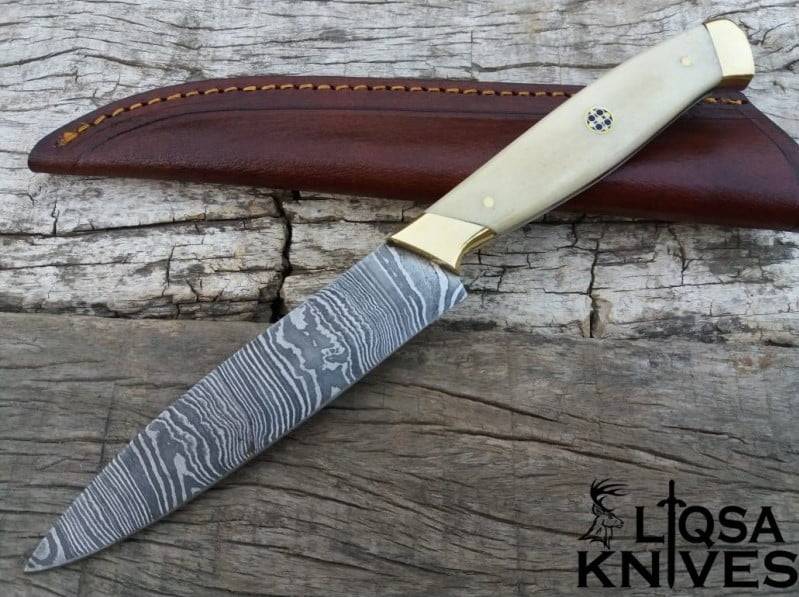 A beautifully crafted Handmade Damascus Chefs Knife with a full tang construction, brass bolsters, and a comfortable camel bone handle, ready to tackle any culinary challenge.