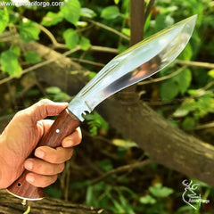 Man chopping wood with the powerful Kukri Knife For Sale, showing its utility and strength.