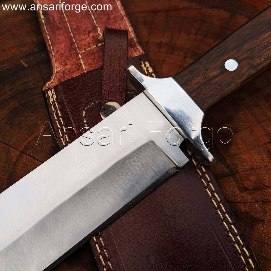 Red Dead Redemption 2 Bowie Knife handle, showcasing the rich rosewood grain and stainless steel guard.