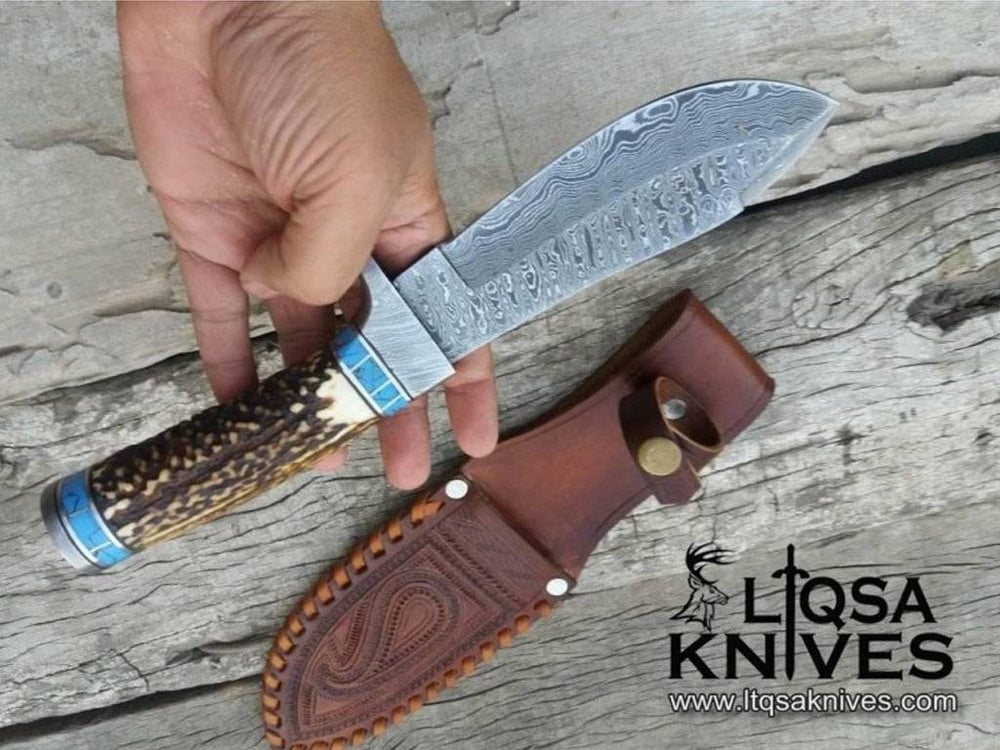 Best Fixed Blade hunting Knife with a drop point blade and a Damascus steel hilt and pommel.