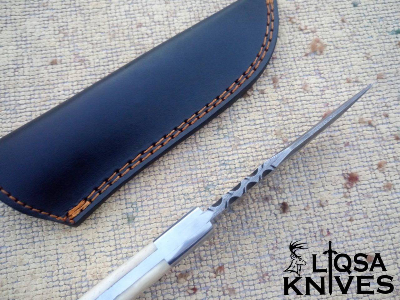 Full tang fixed blade bone handle Damascus knife along with black leather sheath.