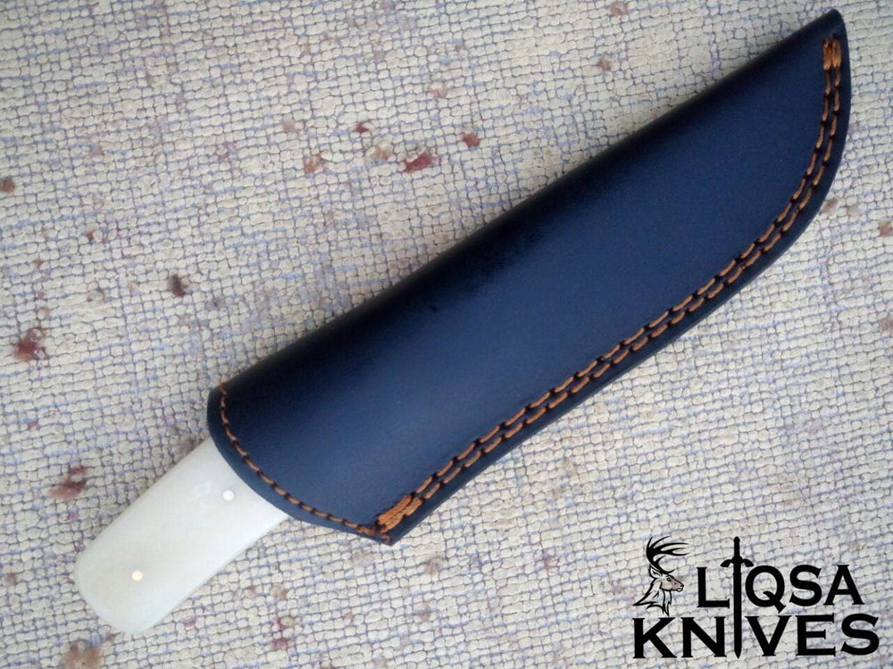 Bone Handle Damascus Knife is in its handmade leather sheath, designed for easy belt attachment and secure storage.