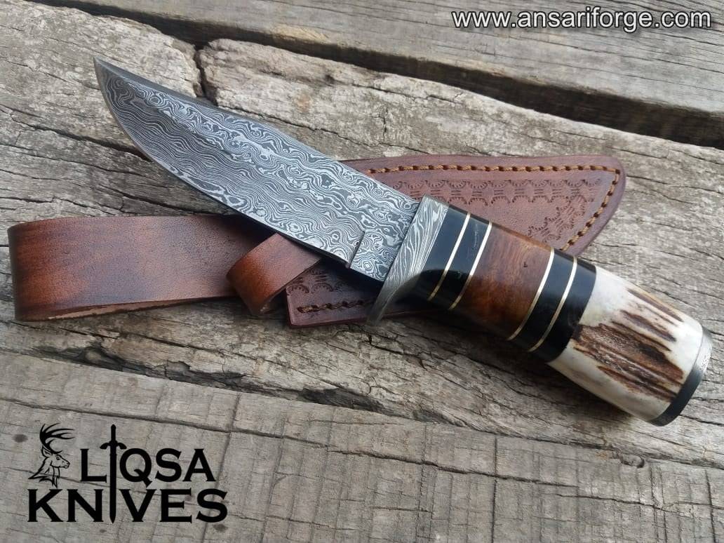 Handmade Custom Damascus Hunting Knife with Stag Antler Handle and Rain Drop Pattern.
