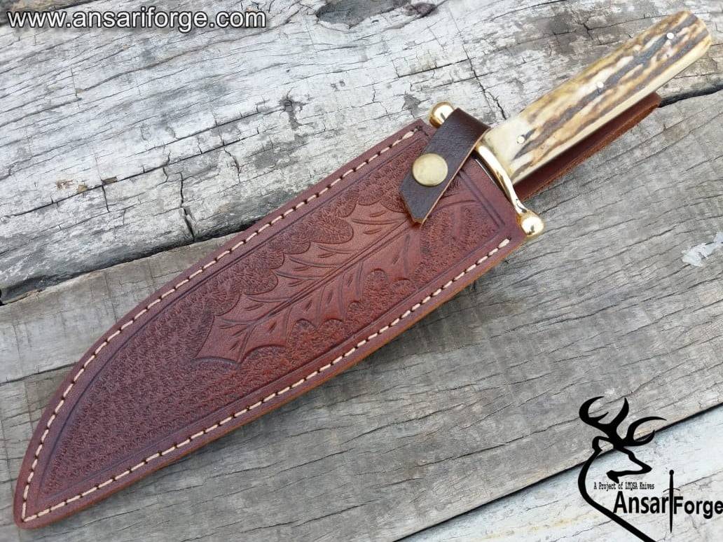 5160 Bowie Knife Displayed with Tooled Leather Sheath and Antler Handle.