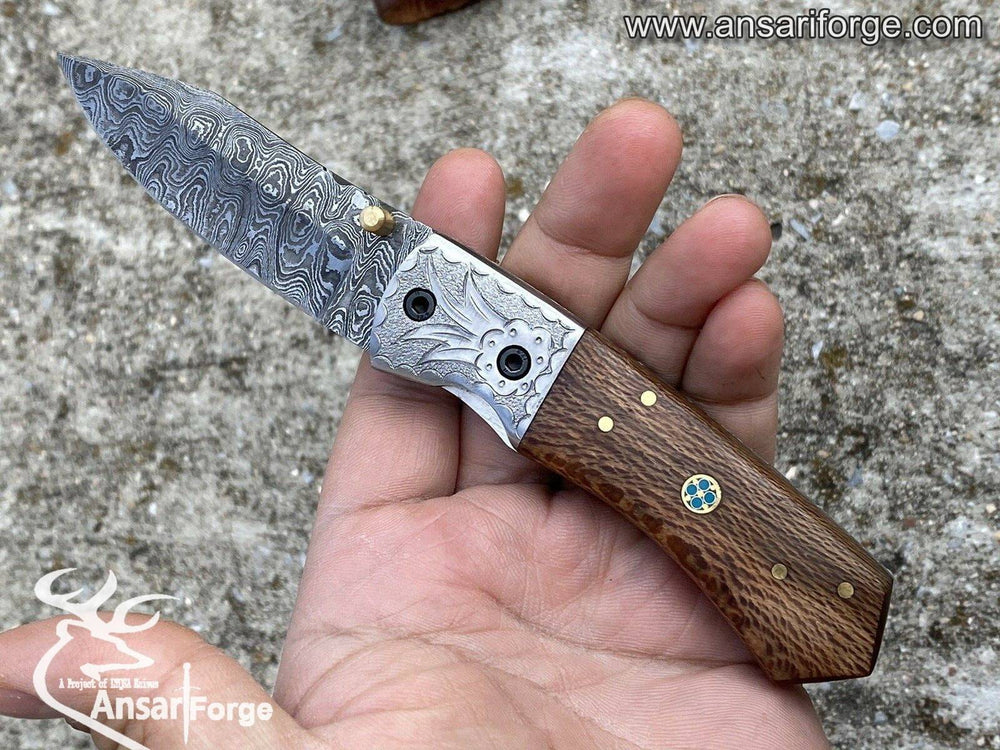 A hand-forged Damascus steel folding knife with a beautiful ladder pattern and a sturdy liner lock.